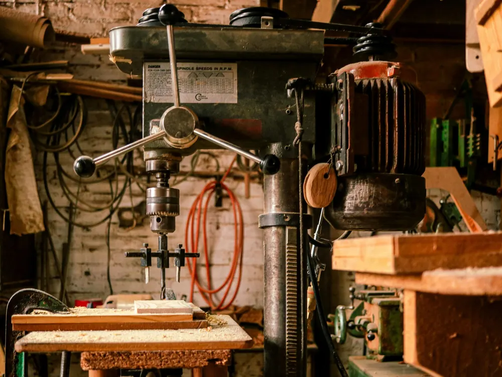 Drill press and hand tools in a workshop