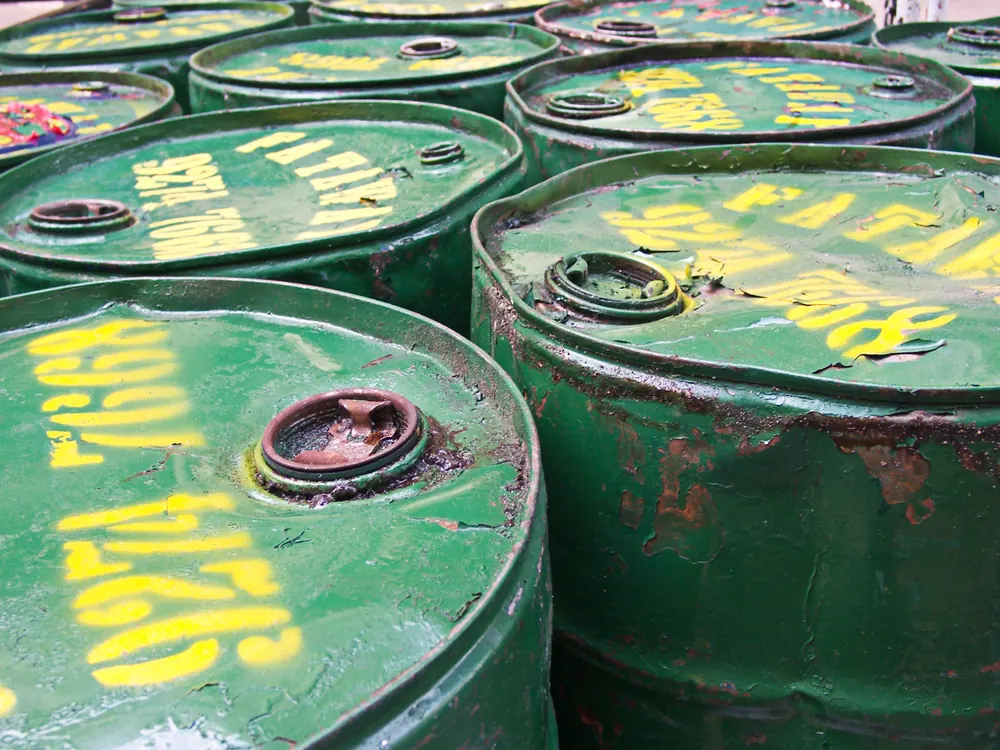 Close-up of weathered green steel drums