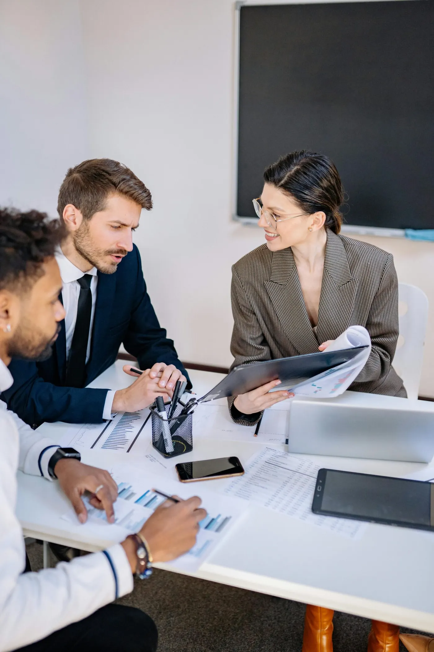 Colleagues reviewing documents together around a table