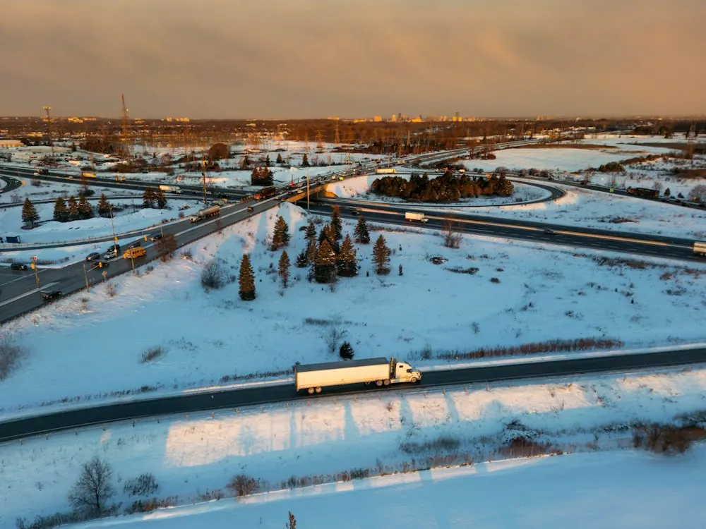 Transport truck on a snow-covered highway interchange