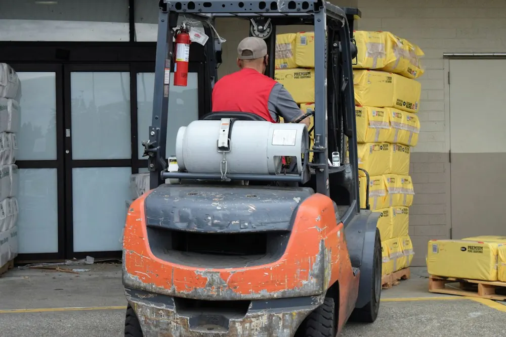 Operator driving a forklift in a warehouse
