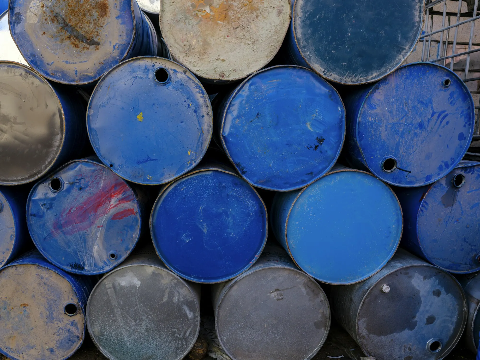 Stacked blue and grey steel drums